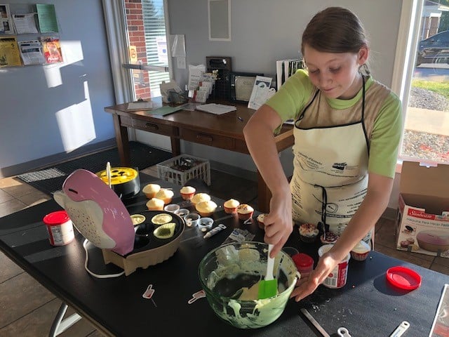 Young girl making cupcakes
