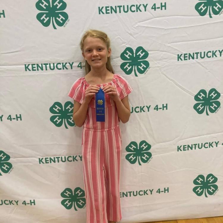  Girl wearing pink holding blue ribbon