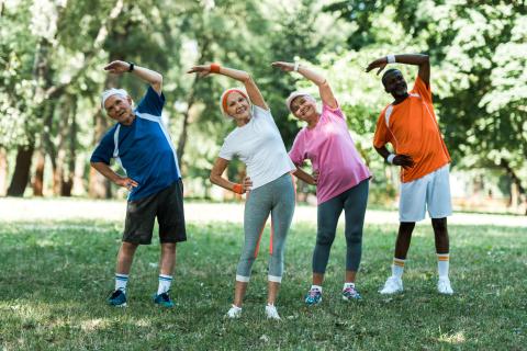 men and women stretching outside